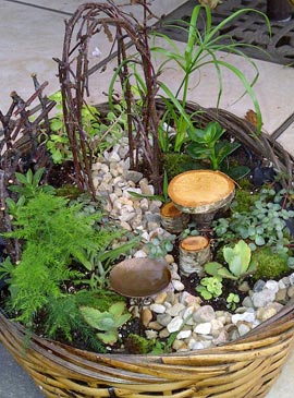 This fairy garden uses twigs for an arbor and is built in a wicker basket.